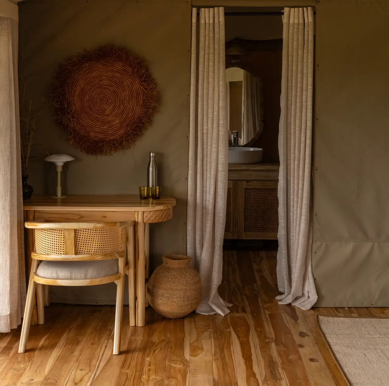 Tent bedroom writing desk and ensuite bathroom entrance at Conserve Safari Tarangire