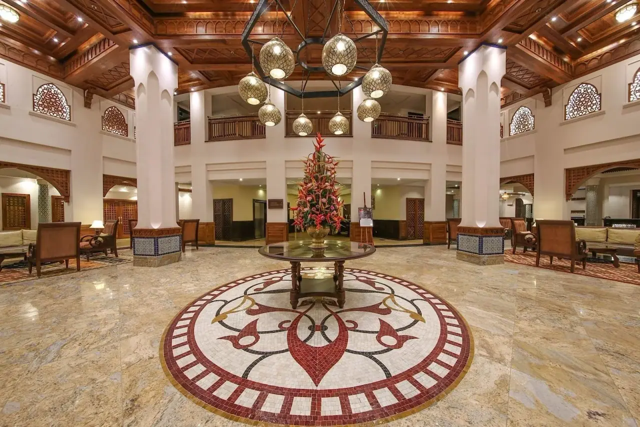 Grand double-height lobby with a mosaic marble floor and hanging lantern chandelier at Dar es Salaam Serena Hotel