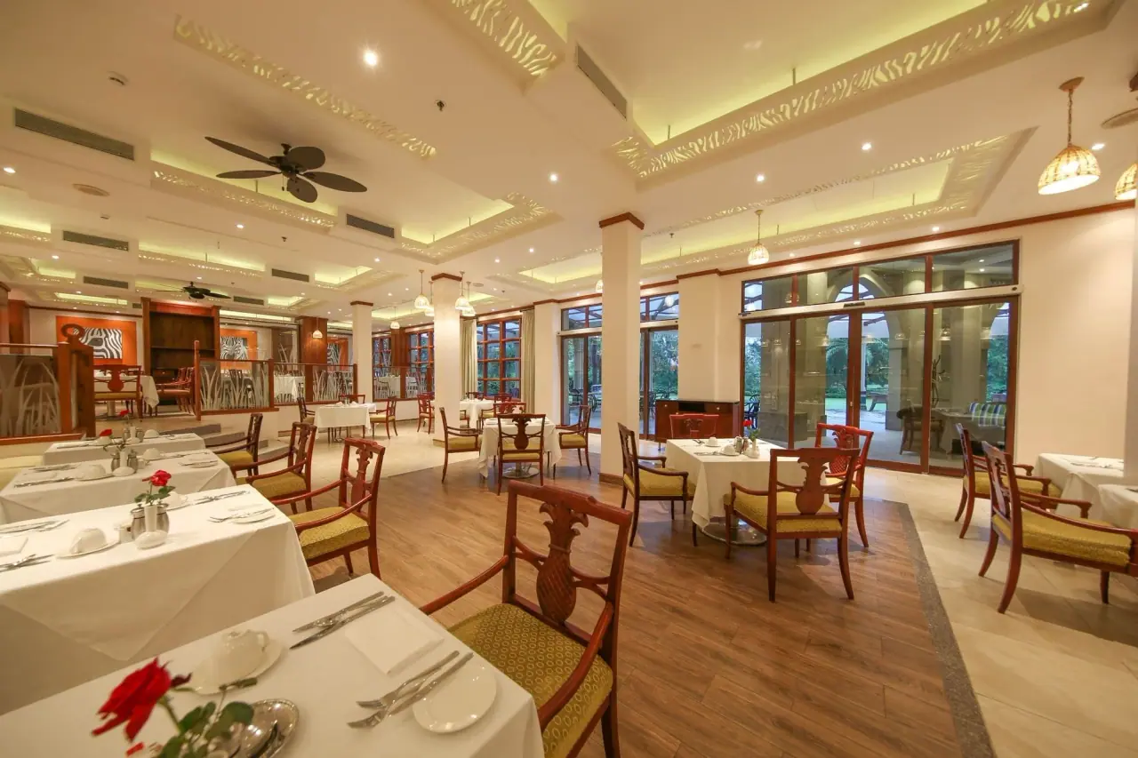 Zebra-themed restaurant dining room set with white tablecloths at Dar es Salaam Serena Hotel