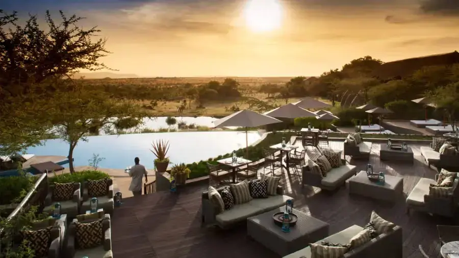 Sunset terrace lounge seating overlooking the lodge's own watering hole at Four Seasons Safari Lodge Serengeti