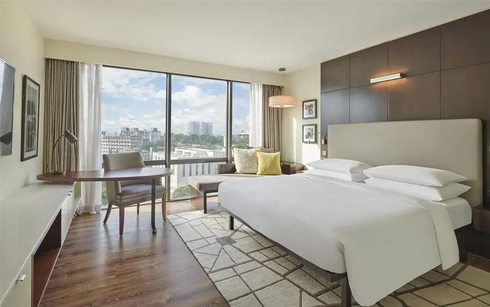 Modern guest room at Hyatt Regency Dar es Salaam with a king bed and floor-to-ceiling windows over the city skyline