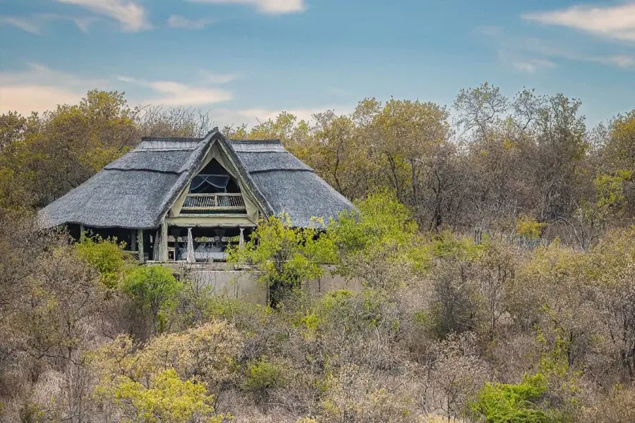 Thatched Ikuka Camp lodge perched on a rocky outcrop surrounded by Ruaha bushland
