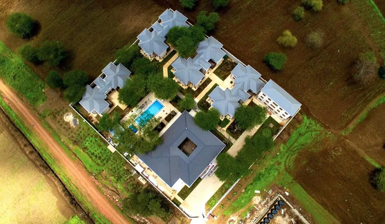 Aerial view of Kahawa House cottages, pool and gardens set within the working coffee estate
