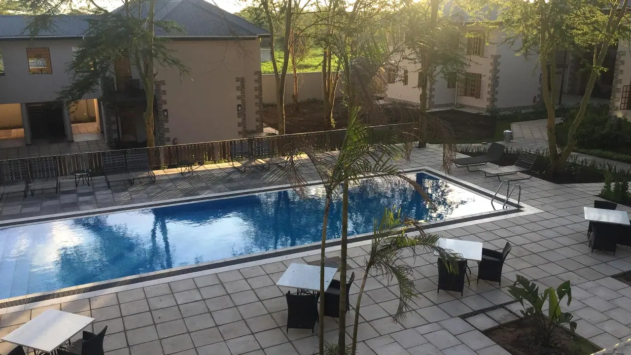 Kahawa House swimming pool and paved terrace with loungers at golden hour