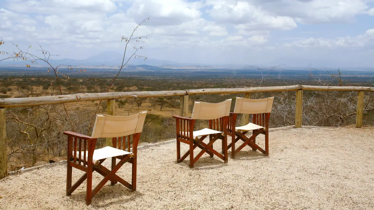 Canvas director's chairs on a viewpoint deck at Kambi ya Tembo overlooking the West Kilimanjaro plains