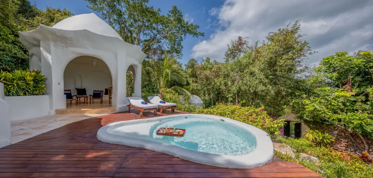 Domed white pavilion and private plunge pool at Kilindi Zanzibar with a floating breakfast tray
