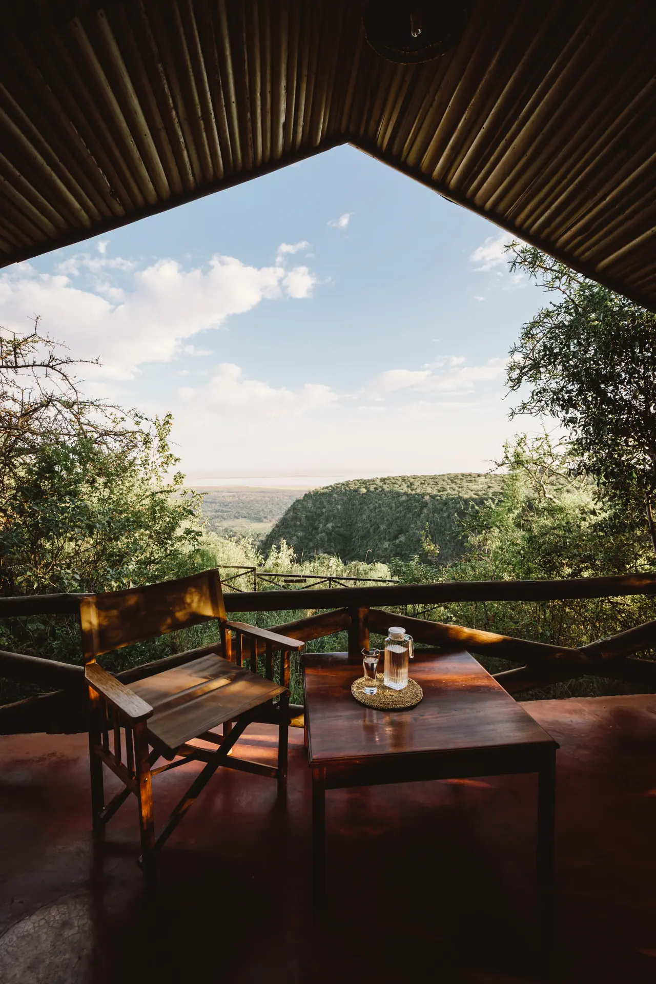 Private deck with table and chairs perched on the Rift Valley escarpment at Kirurumu Manyara Lodge