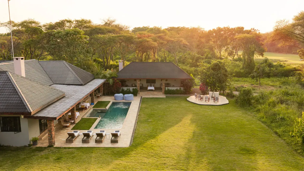 Aerial view of the house, pool and gardens on the golf and wildlife estate at golden hour