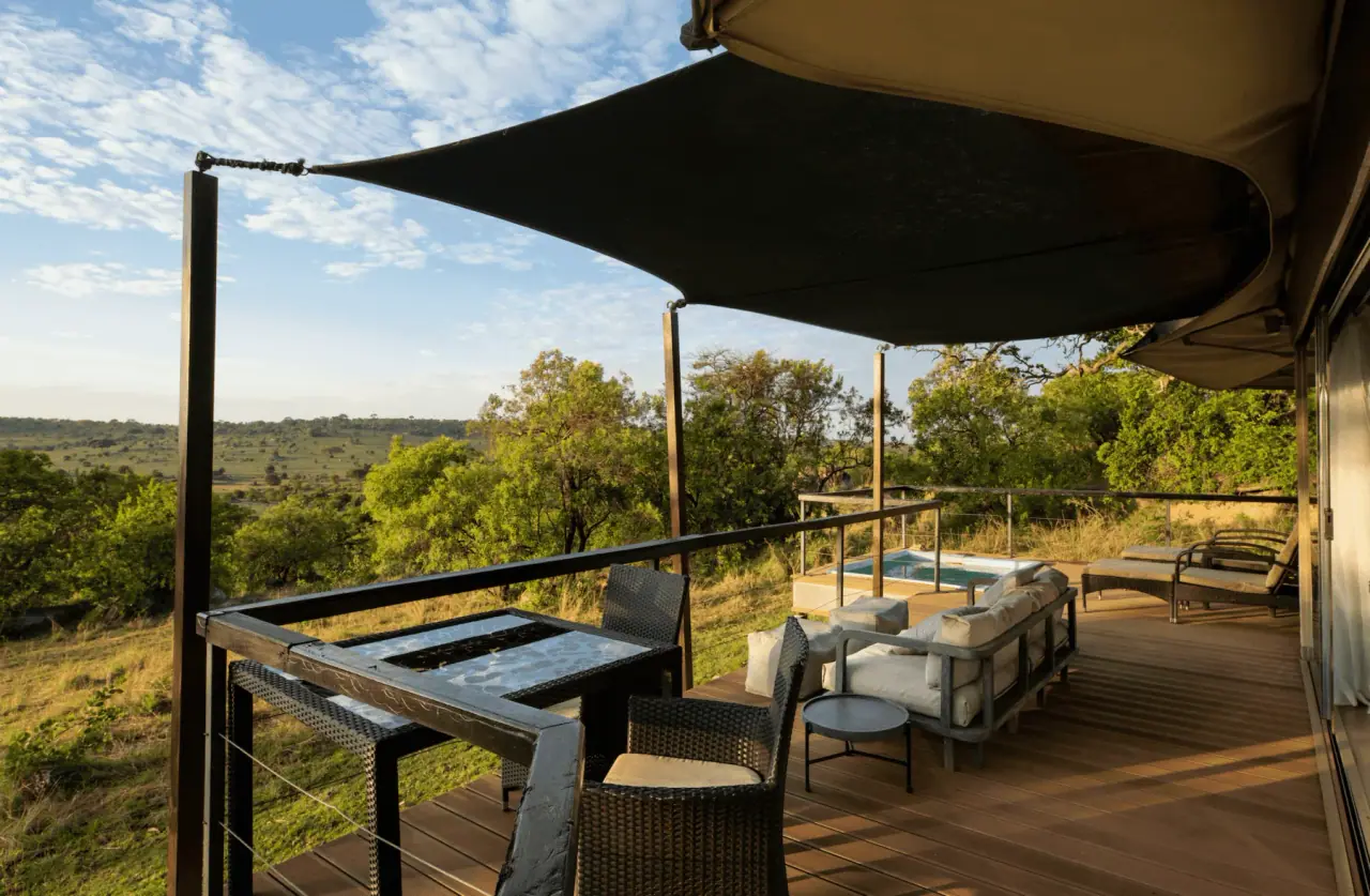 Private deck with a plunge pool and lounge seating overlooking the northern Serengeti plains at Lemala Kuria Hills