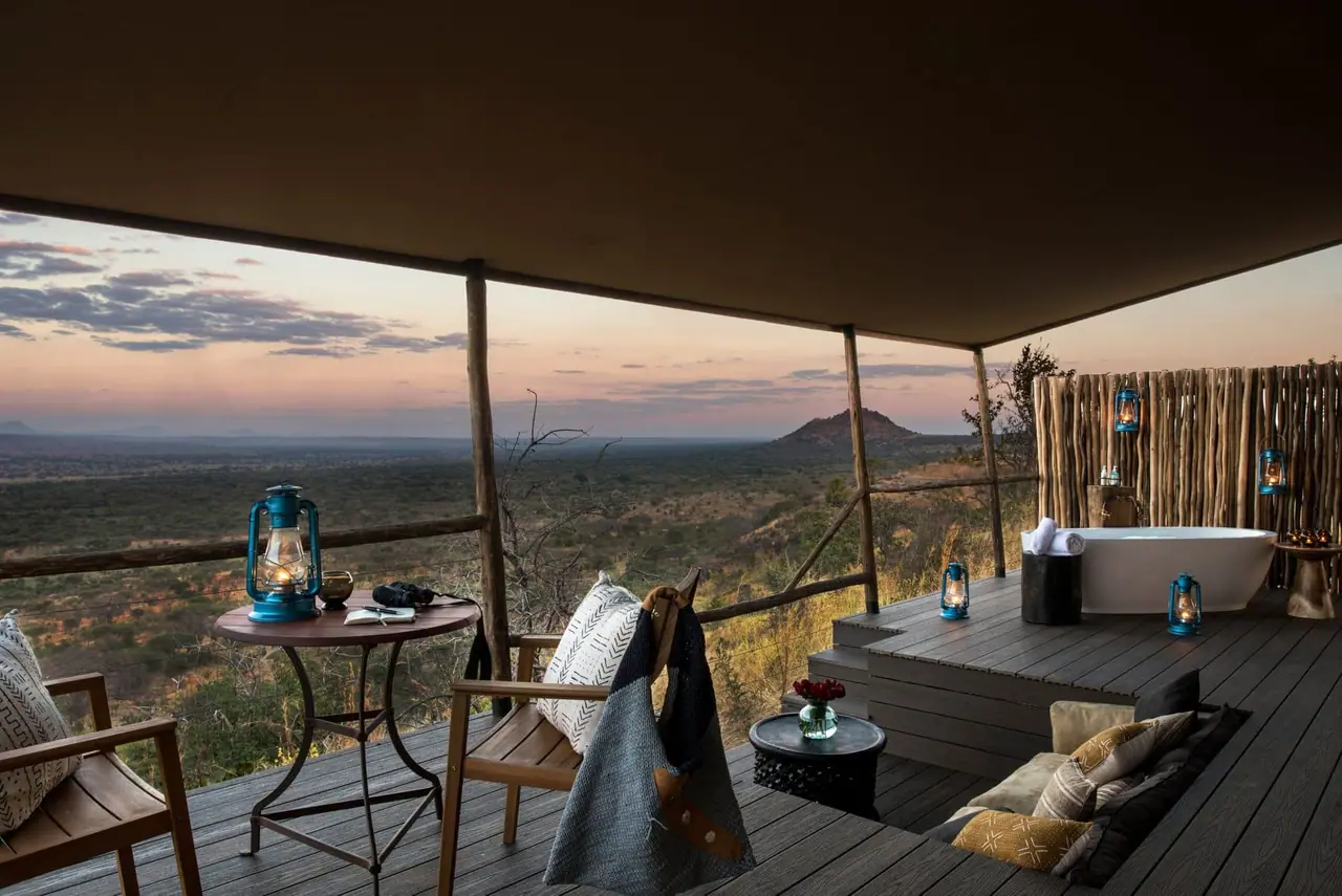 A suite deck with an outdoor bathtub looking over the valley at dusk