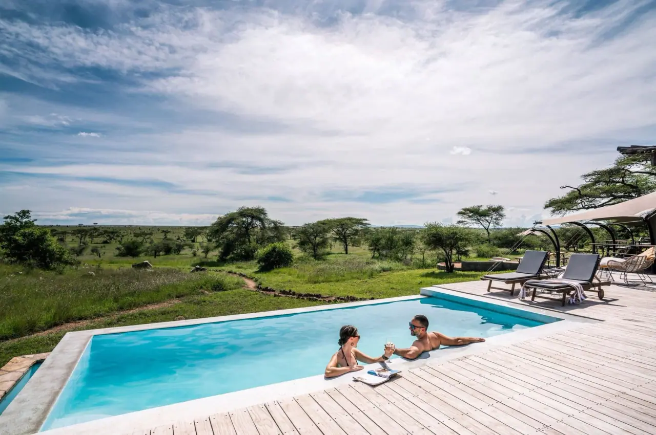 Couple relaxing in the infinity pool overlooking the plains at Lemala Nanyukie
