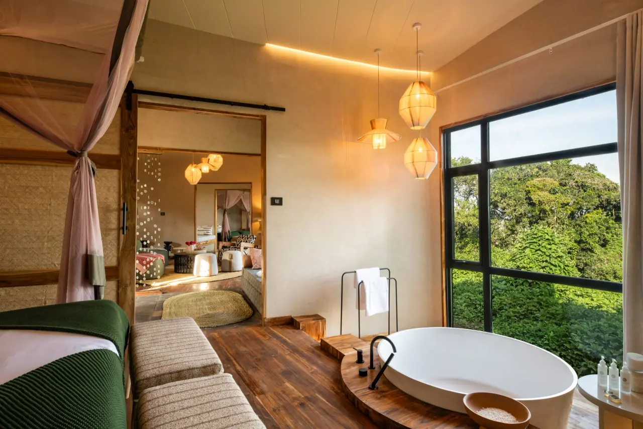 Suite bathroom at Lemala Osonjoi with a freestanding tub set beneath a floor-to-ceiling forest-view window