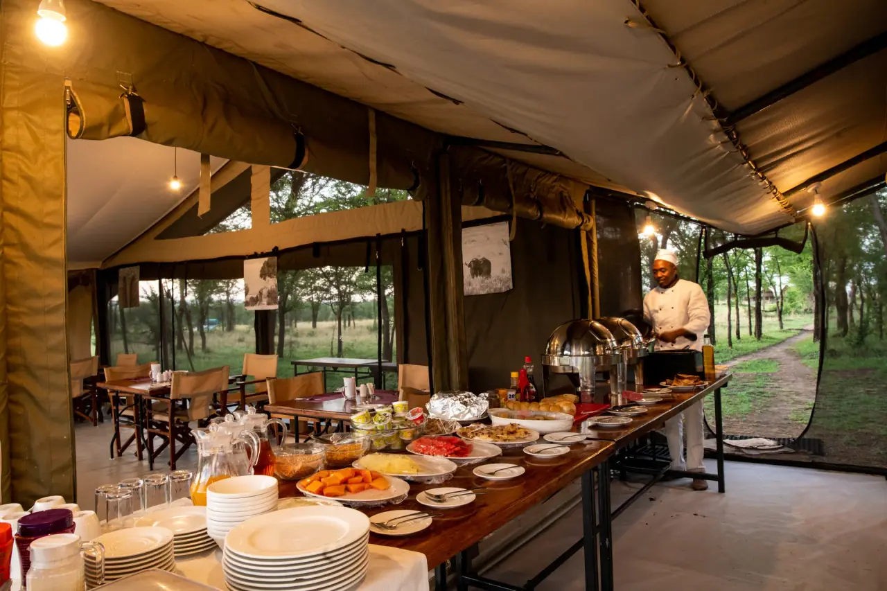 Chef preparing a hot breakfast buffet inside the mess tent at Mara Katikati Tented Camp