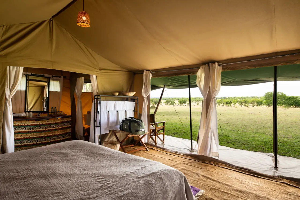 Tent dressing area with vanity basin at Mara Under Canvas opening onto the Serengeti plains