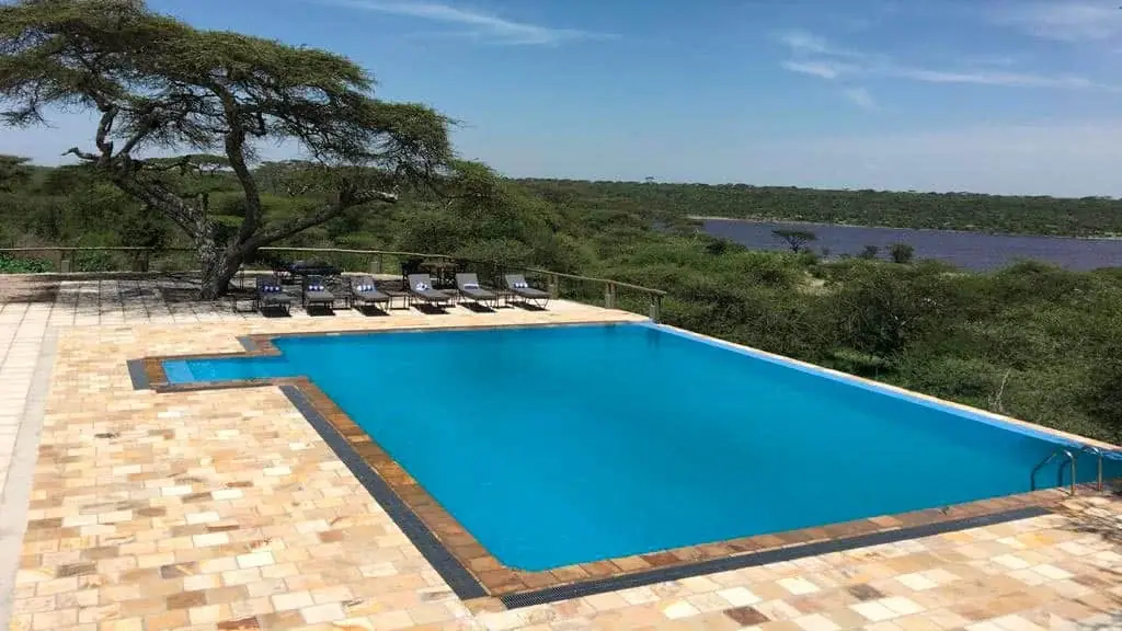 Swimming pool at Masek Tented Lodge overlooking Lake Masek and the surrounding plains