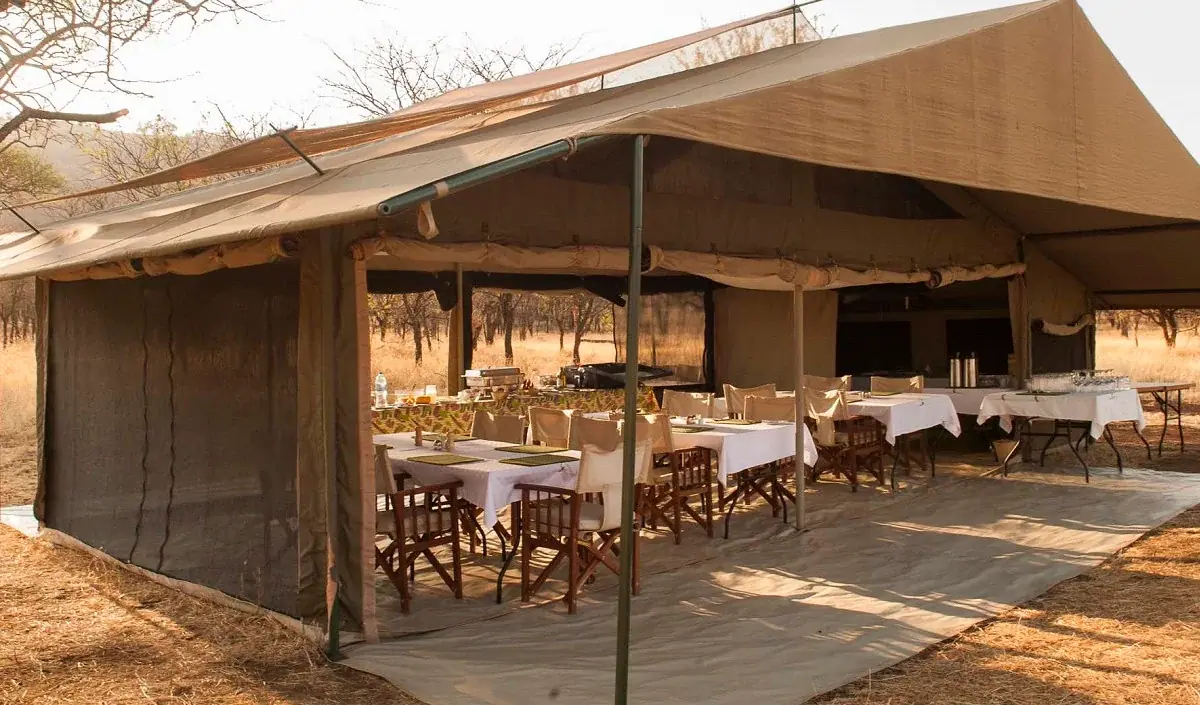 Open-sided dining tent at Ndutu Kati Kati Tented Camp set for a group meal