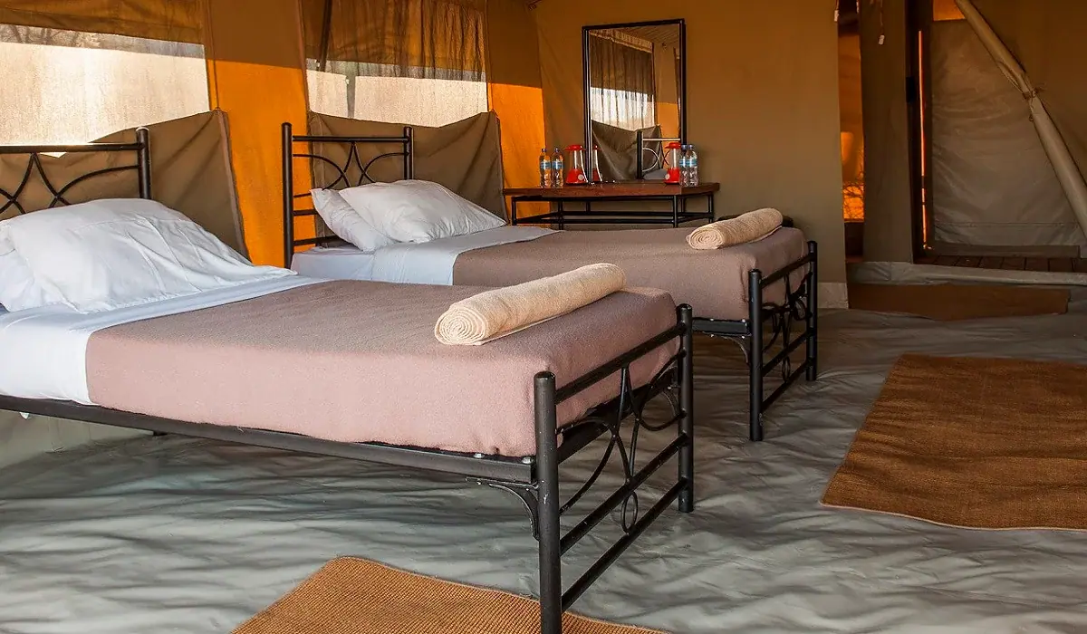 Twin beds inside a guest tent at Ndutu Kati Kati Tented Camp