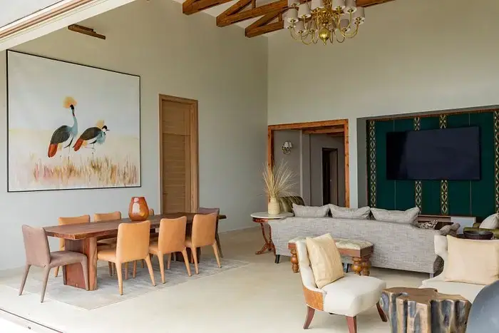 Open-plan living and dining room at Ngorongoro Lodge, The Rim Room (Meliá Collection), with a crowned crane painting