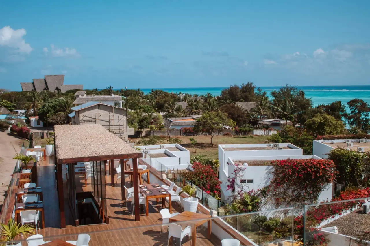 Rooftop restaurant terrace with ocean views and bougainvillea at Nungwi Dreams By Mantis
