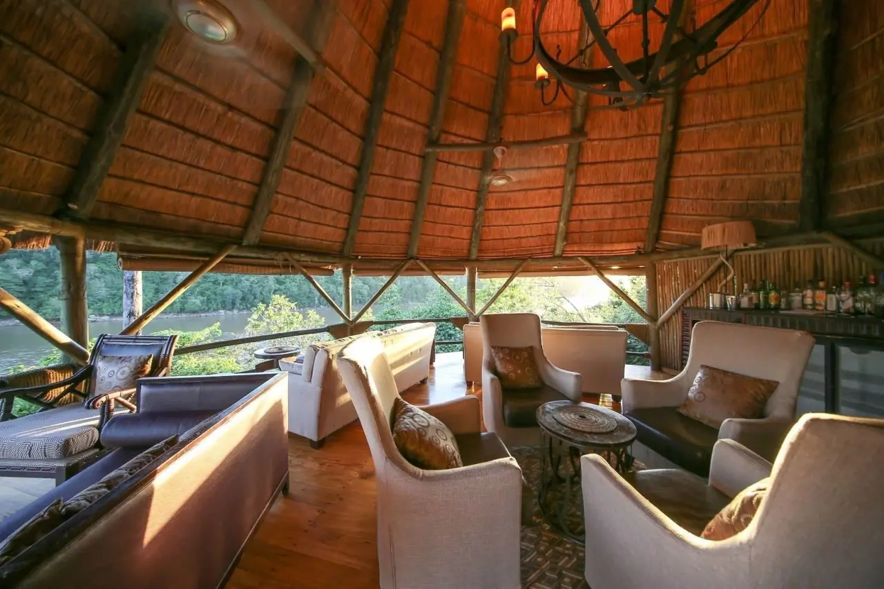 Thatched lounge and bar area overlooking the Rufiji River at Serena Mivumo River Lodge