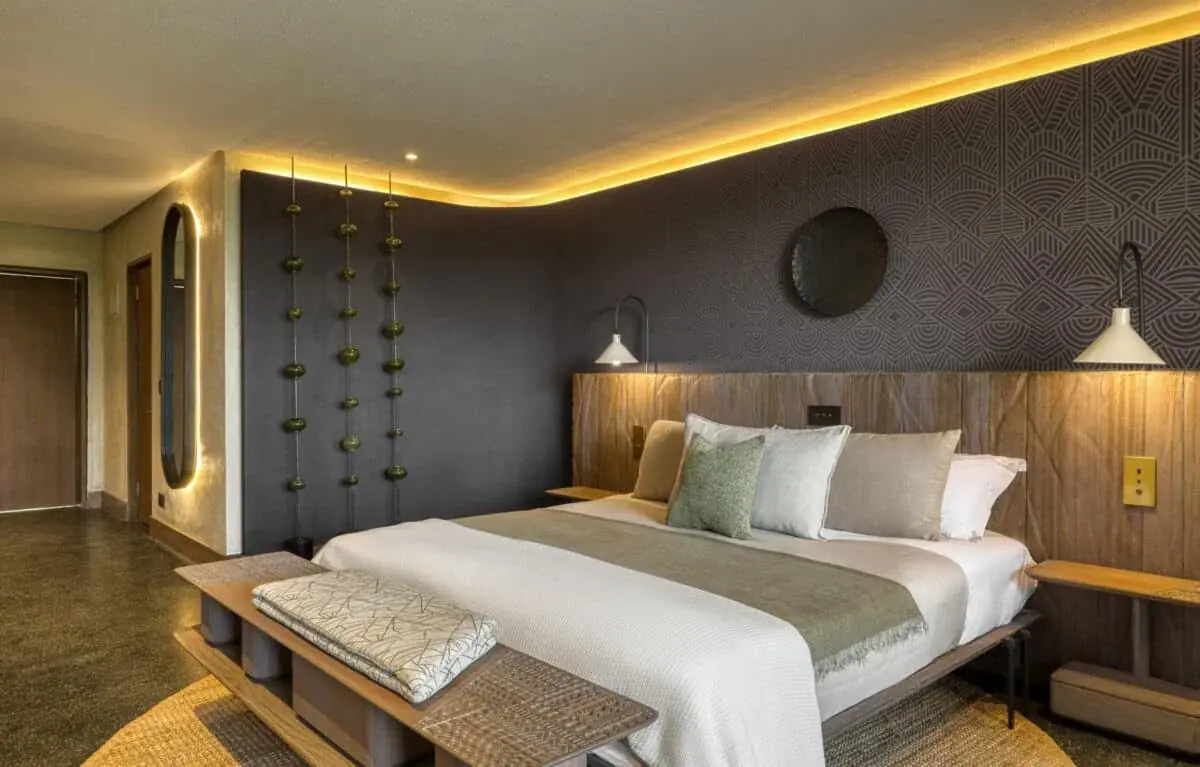Suite bedroom with dark patterned wallpaper and warm lighting at Serengeti Explorer
