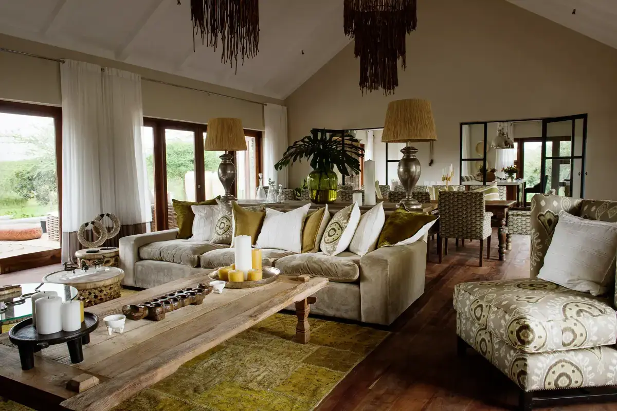 Open-plan living and dining room at Siringiti Arusha Villa with a sectional sofa and vaulted ceiling