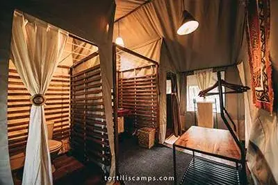 En-suite bathroom with slatted wood partitions at Tortils Ngorongoro Camp