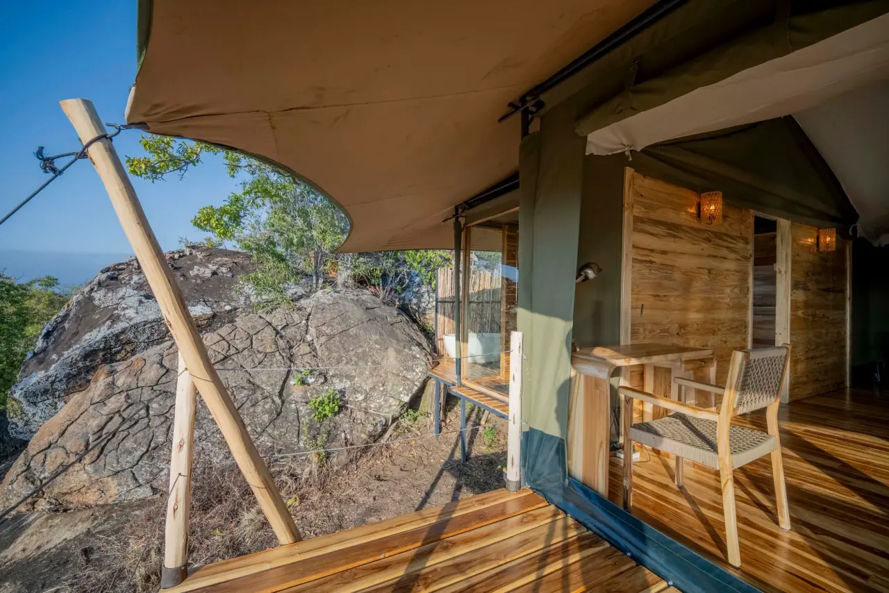 Guest tent deck built beside a large granite rock outcrop at Zuri Kilima Siri with an outdoor bathtub