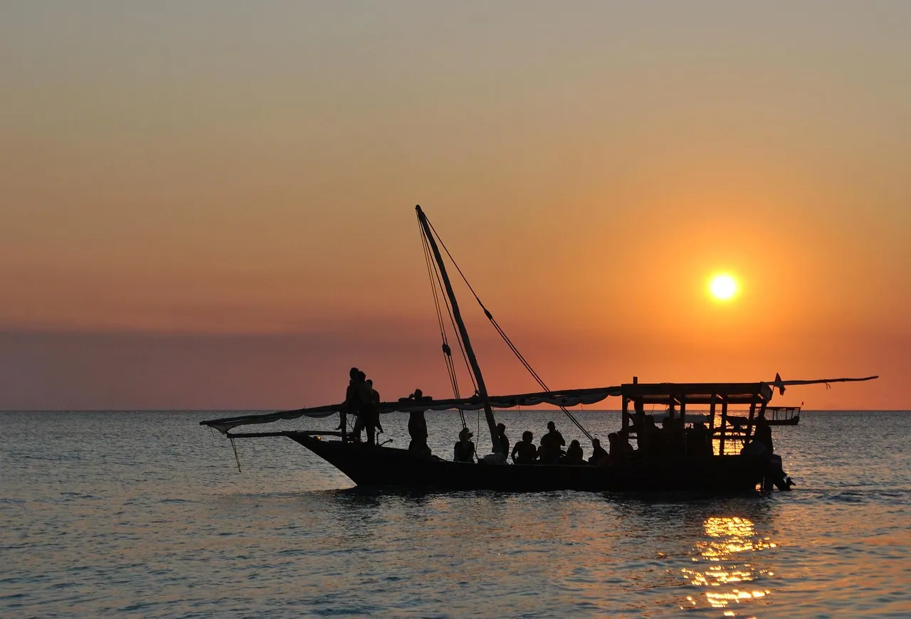 A dhow silhouetted against the setting sun