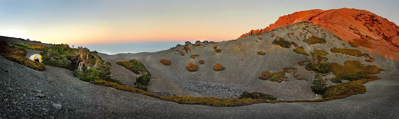 Barren high moorland under a pink dawn sky