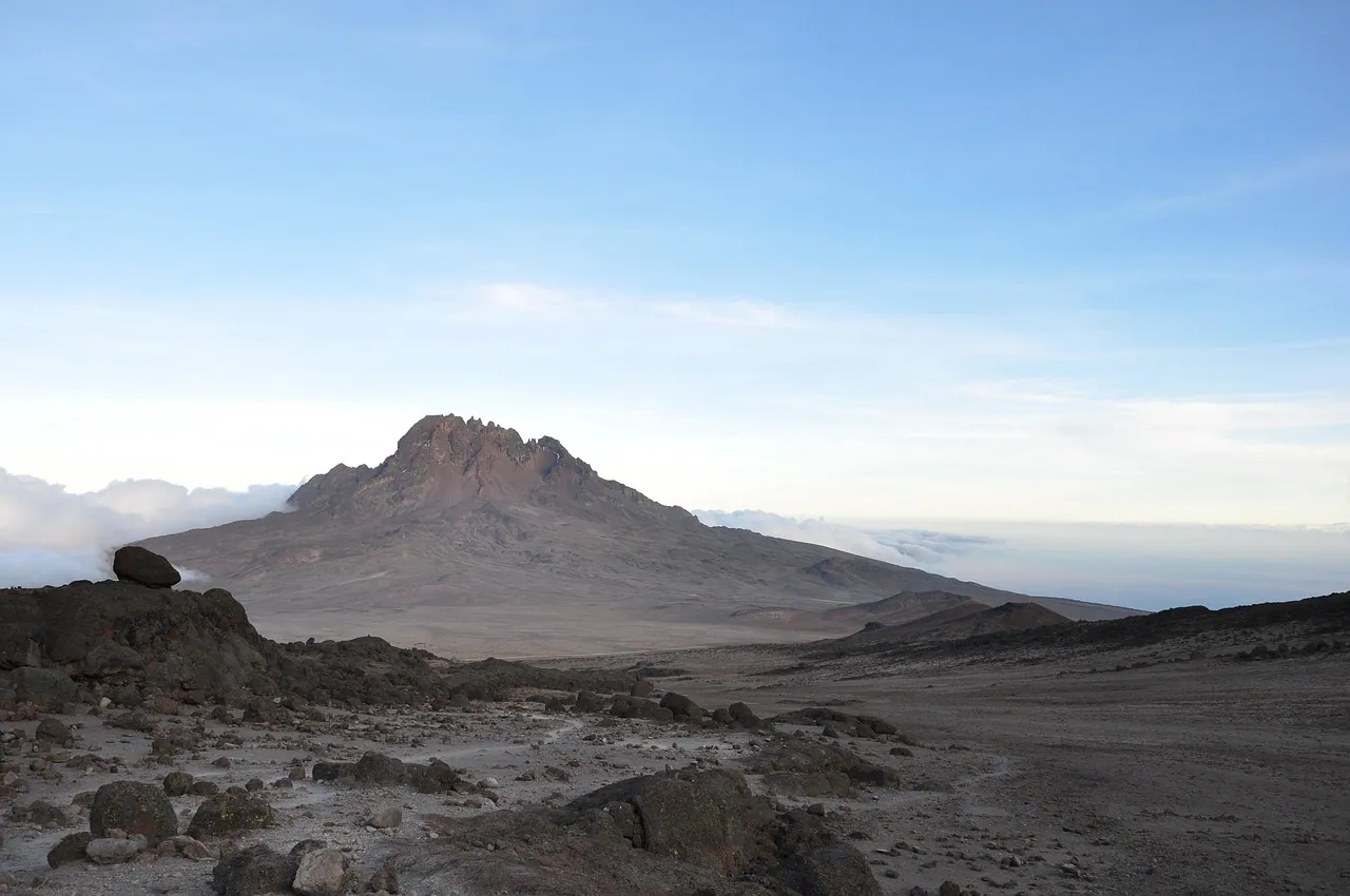 A rocky volcanic ridge under a blue sky